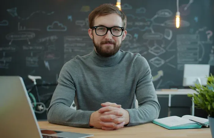 Professional with glasses at a desk in an office, highlighting expert help available via the local listing guide